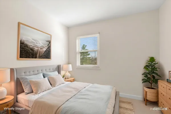 a bedroom with a bed and a potted plant
