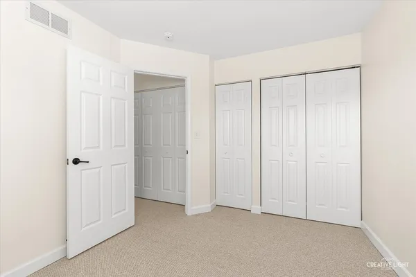 a view of an empty room with closet area