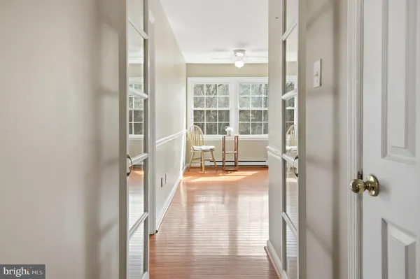 a view of a hallway with wooden floor and stairs
