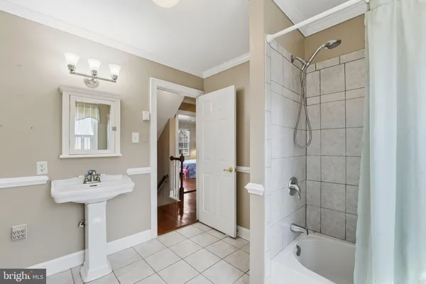 an empty room with wooden floor closet and fan