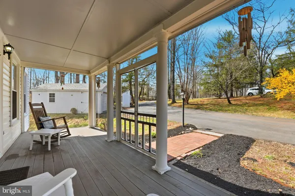 a view of a house with snow on the side of the road