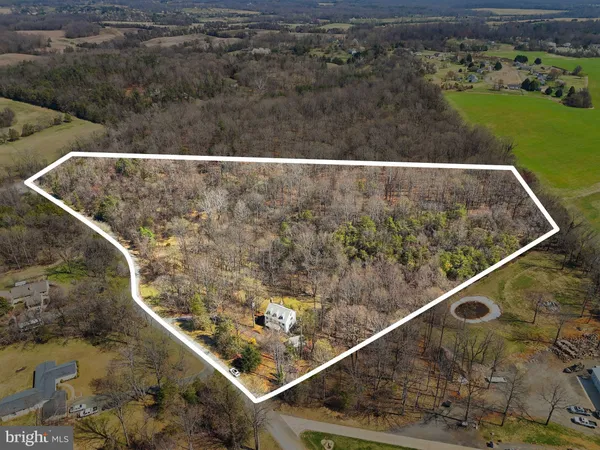 a view of a house with a yard chairs and table in the patio