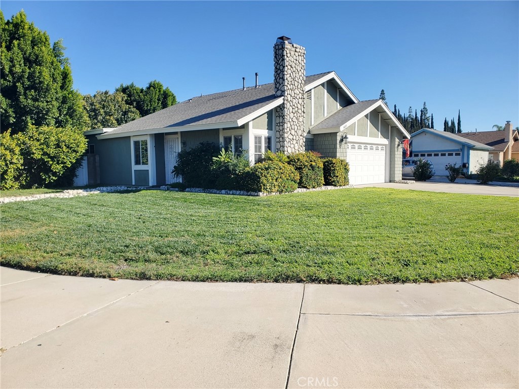 4459 Clarksdale Drive Riverside, CA 92505 - Photo 2 of 12 a front view of a house with a yard and garage
