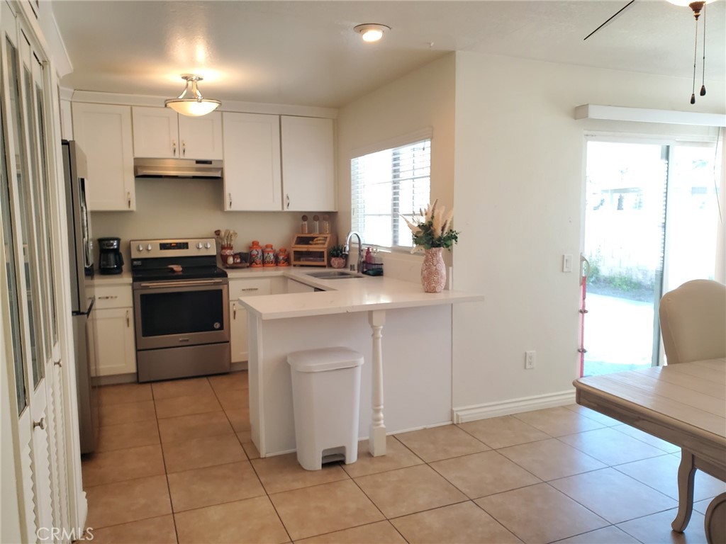 4459 Clarksdale Drive Riverside, CA 92505 - Photo 5 of 12 a kitchen with a stove a sink and a refrigerator