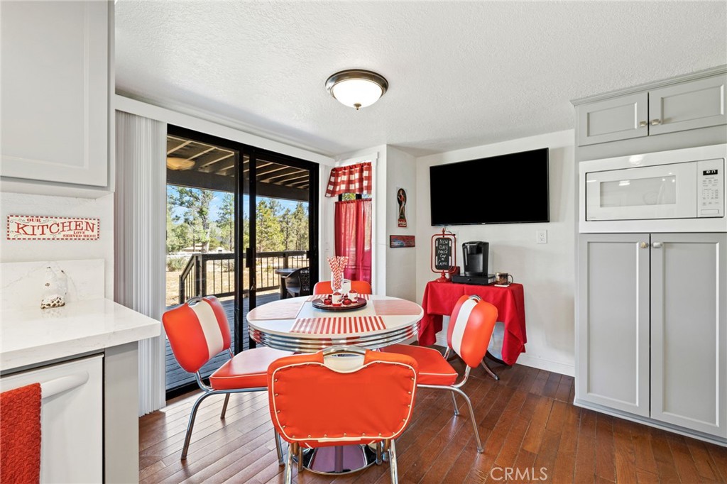 61116 Devils Ladder Road Mountain Center, CA 92561 - Photo 20 of 74 a view of a livingroom with furniture a flat screen tv and floor to ceiling window