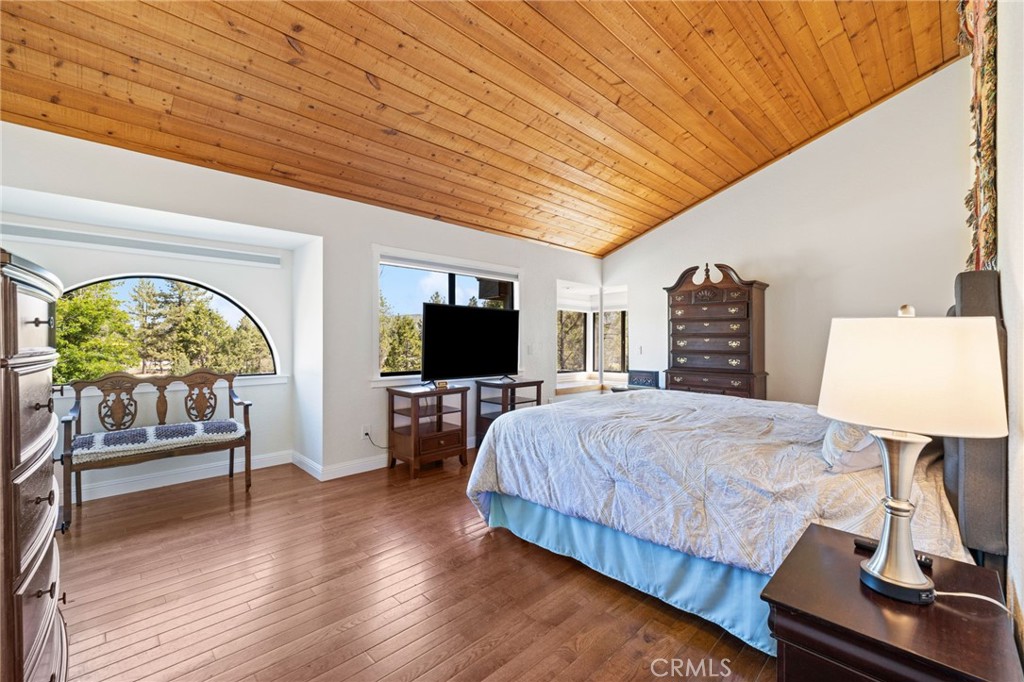 61116 Devils Ladder Road Mountain Center, CA 92561 - Photo 34 of 74 a bedroom with a bed and a flat screen tv