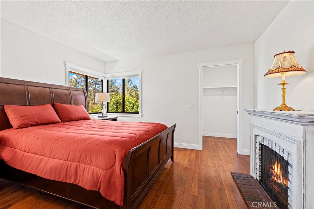 61116 Devils Ladder Road Mountain Center, CA 92561 - Photo 46 of 74 a bedroom with a bed and a fireplace