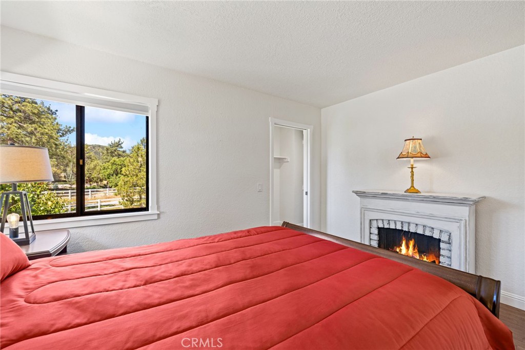 61116 Devils Ladder Road Mountain Center, CA 92561 - Photo 47 of 74 a bedroom with a bed and a fireplace