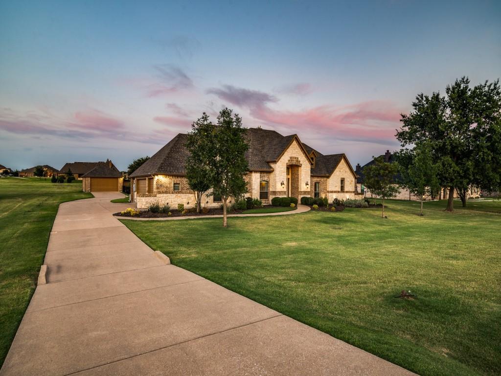 1650 Winding Creek Lane Rockwall, TX 75032 - Photo 1 of 35 French country style house featuring a lawn, stone siding, concrete driveway, and a garage