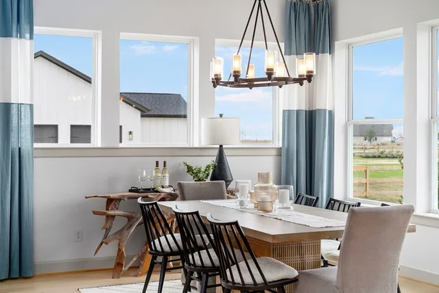 a view of a dining room with furniture and a window