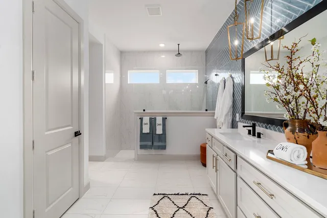 a bathroom with a sink vanity and a mirror