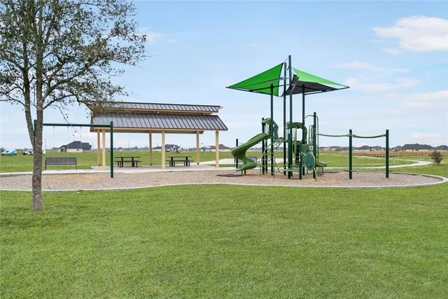 a view of a house with a yard and sitting area