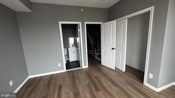 a view of entryway and hall with wooden floor