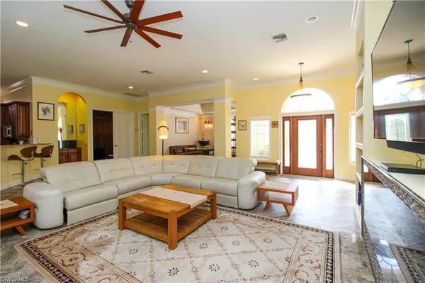 a living room with furniture and a chandelier