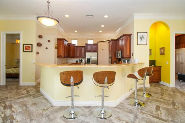 a kitchen with dining table and chairs