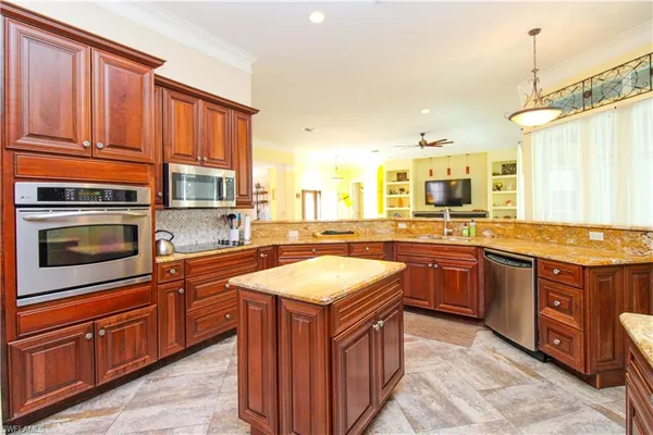 a kitchen with stainless steel appliances granite countertop a sink stove and oven