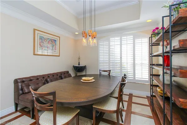a view of a dining room with furniture and a window