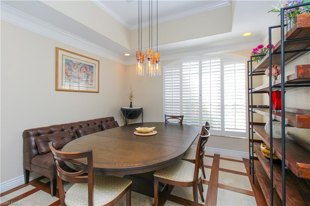 627 Soliel Drive Naples, FL 34110 - Photo 16 of 45 a view of a dining room with furniture and a window