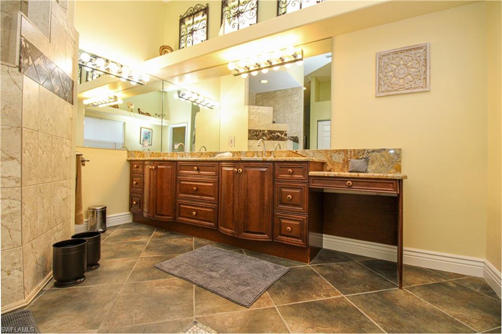 627 Soliel Drive Naples, FL 34110 - Photo 18 of 45 a bathroom with a sink and a mirror