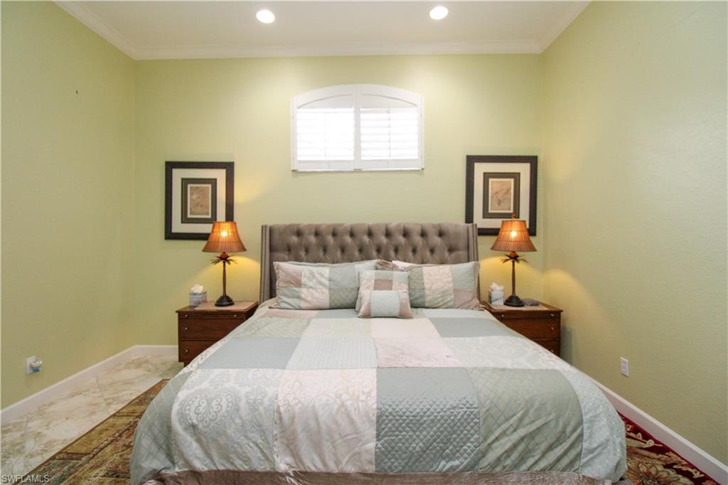 627 Soliel Drive Naples, FL 34110 - Photo 21 of 45 a bed room with a bed and a night stand