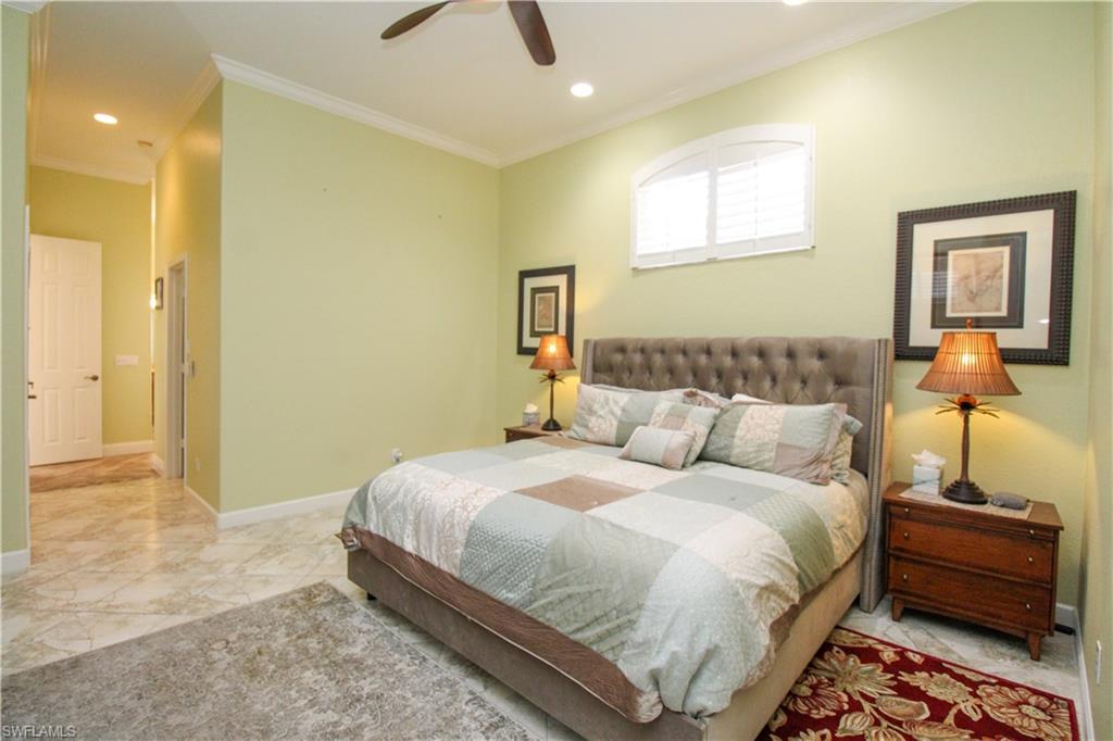 627 Soliel Drive Naples, FL 34110 - Photo 22 of 45 a bedroom with a bed and wooden floor