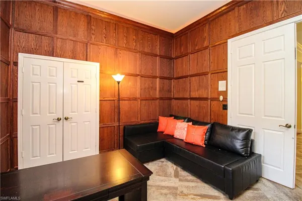 a blue room with wooden floor and furniture