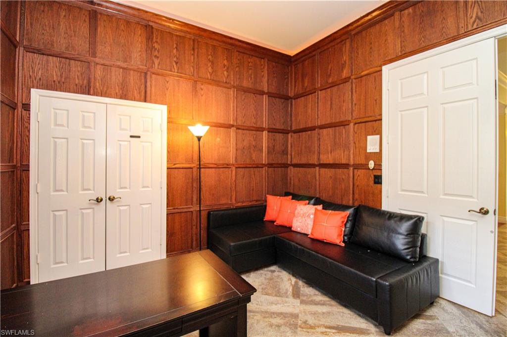 627 Soliel Drive Naples, FL 34110 - Photo 28 of 45 a blue room with wooden floor and furniture