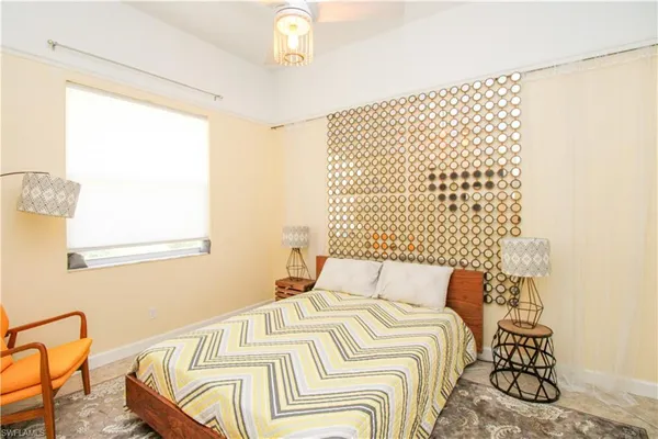 a bedroom with a bed and a painting on the wall