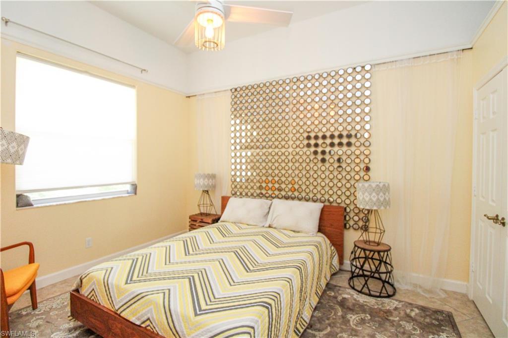627 Soliel Drive Naples, FL 34110 - Photo 36 of 45 a bedroom with a bed and a window