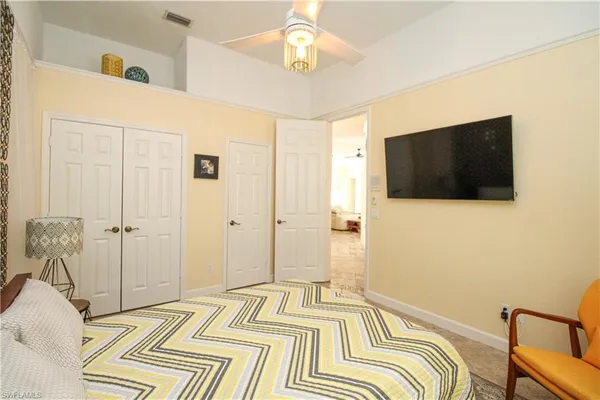 a bedroom with a bed and a flat screen tv