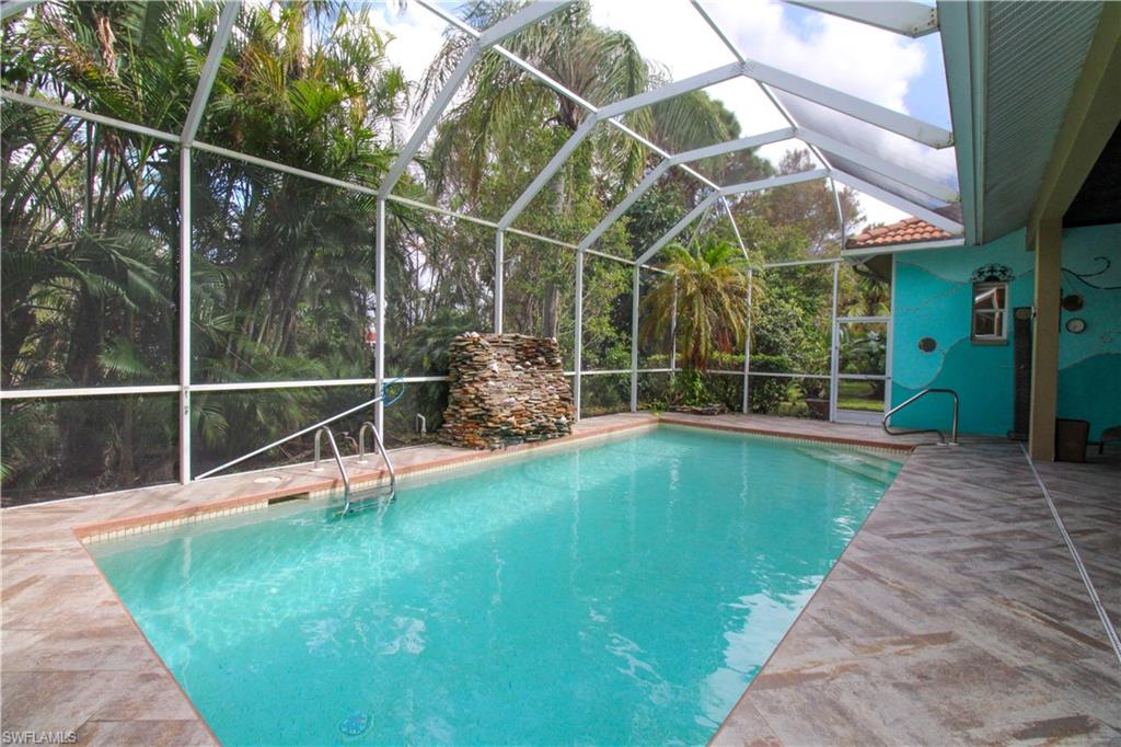 627 Soliel Drive Naples, FL 34110 - Photo 41 of 45 a view of a house with a backyard and a wooden deck