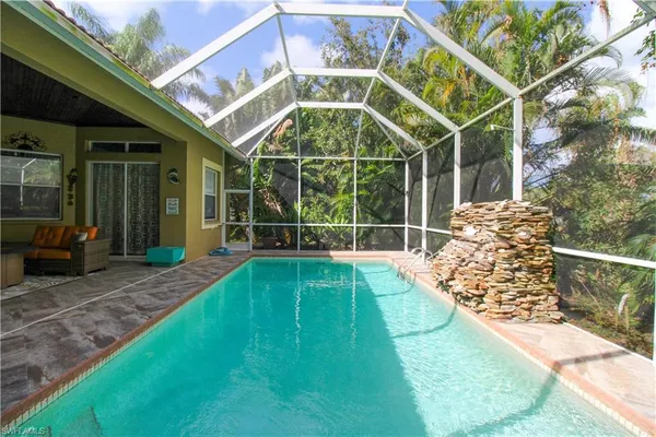 a view of a backyard with table and chairs and a barbeque