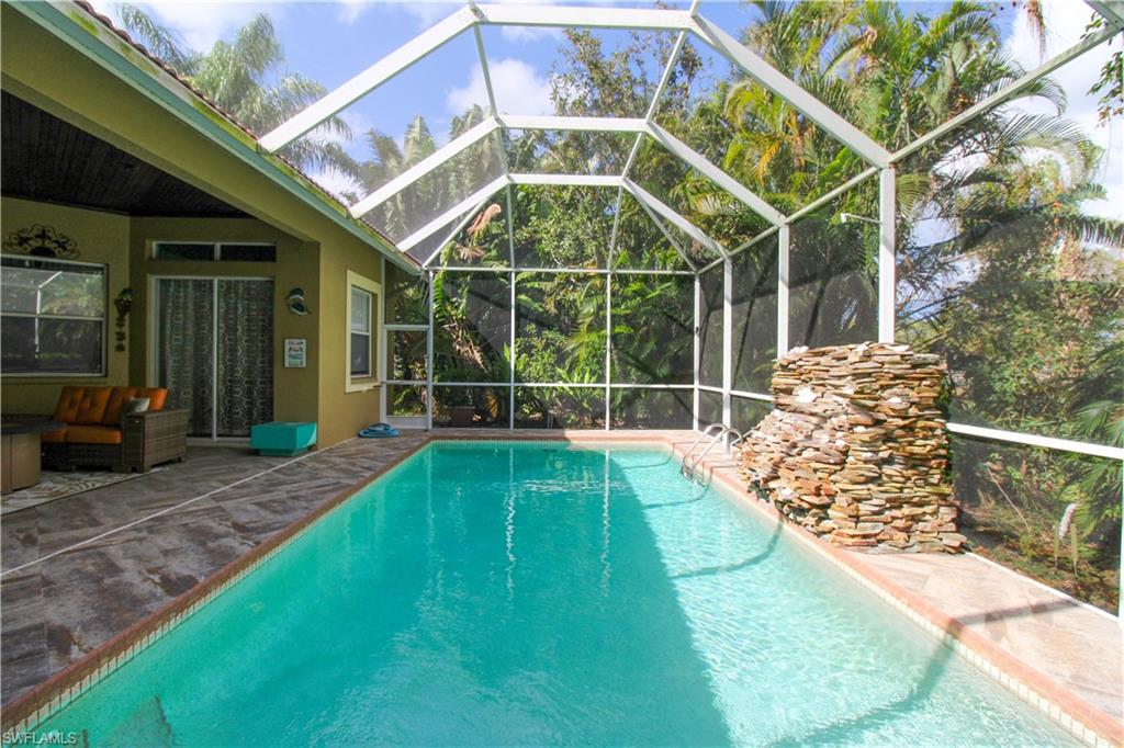 627 Soliel Drive Naples, FL 34110 - Photo 44 of 45 a view of a backyard with table and chairs and a barbeque
