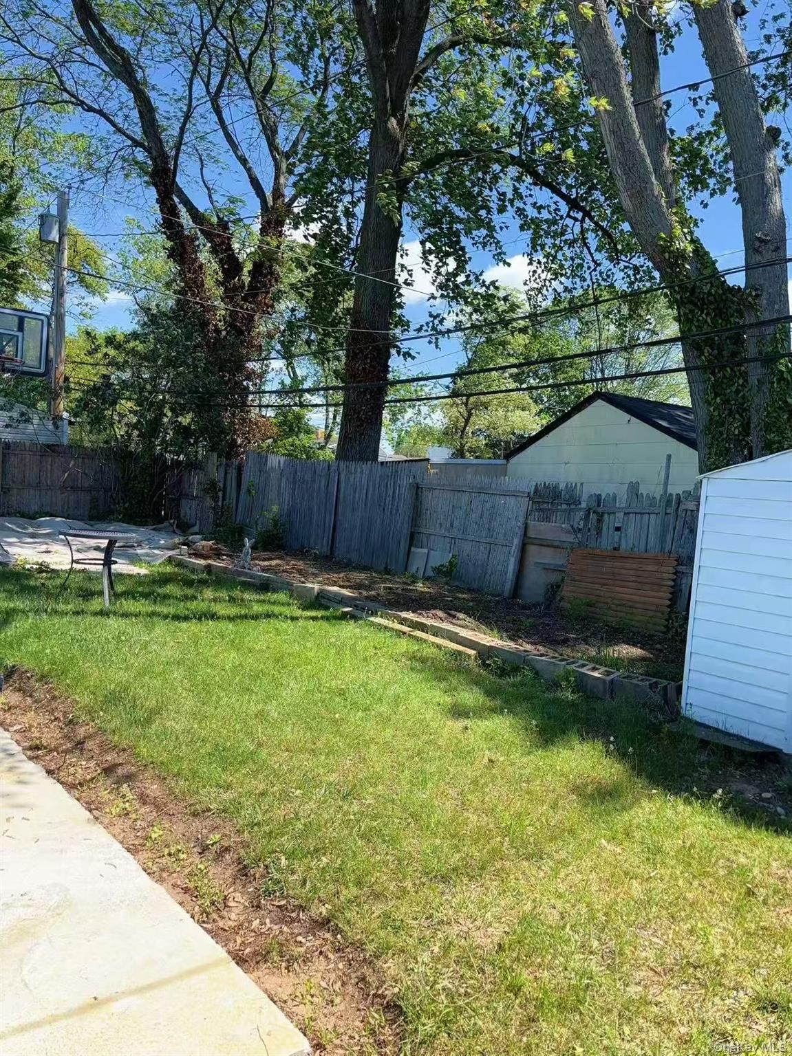 439 Newbridge Road East Meadow, NY 11554 - Photo 13 of 15 a view of a backyard with a garden