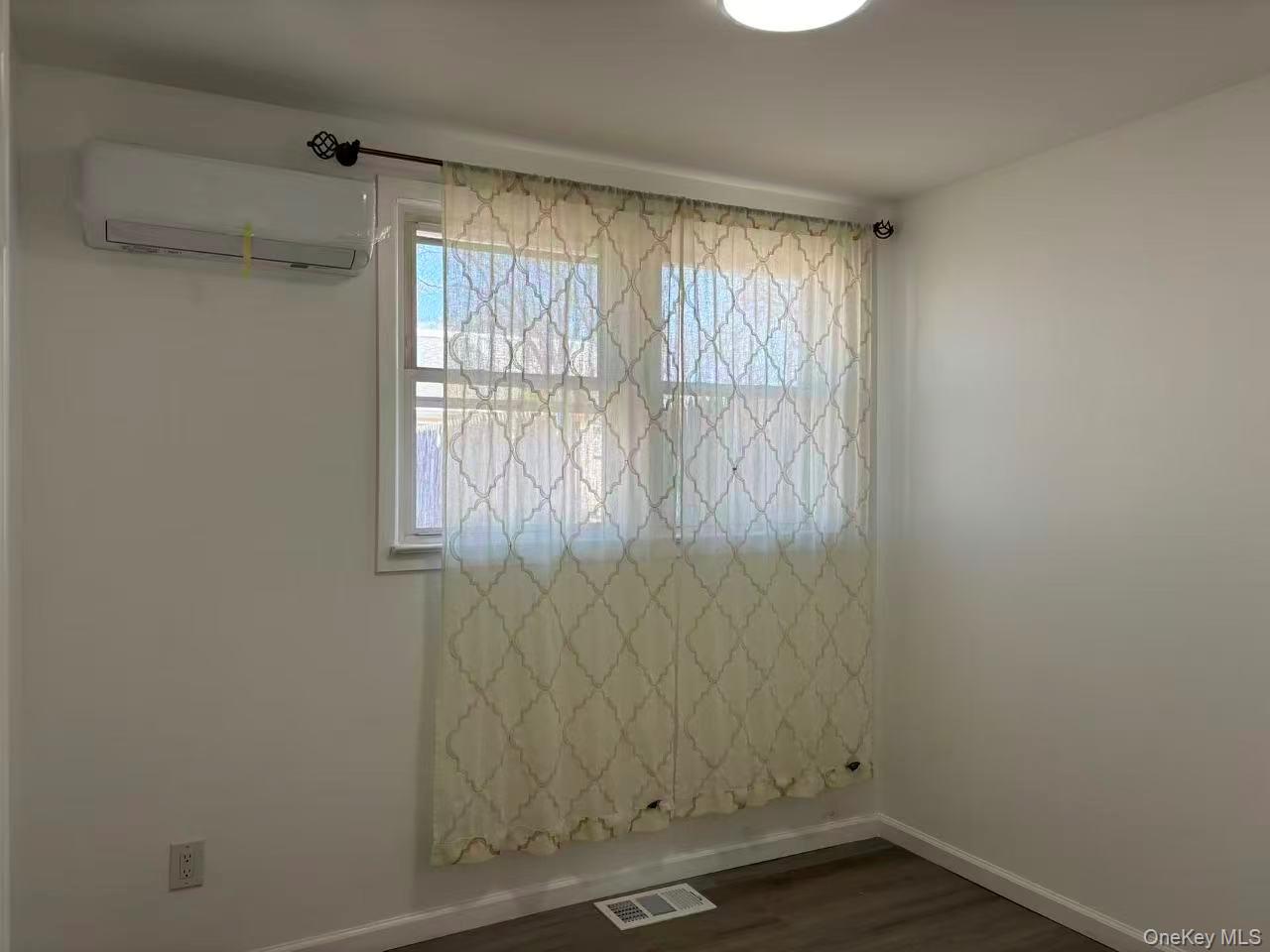 439 Newbridge Road East Meadow, NY 11554 - Photo 6 of 15 a view of an empty room with a window