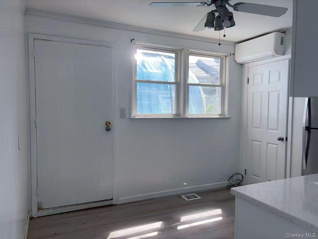 439 Newbridge Road East Meadow, NY 11554 - Photo 7 of 15 an empty room with windows and fan