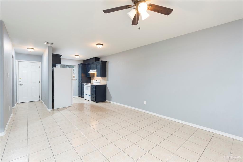 817 South Michigan Street Mission, TX 78573 - Photo 2 of 16 an empty room with chandelier fan and windows
