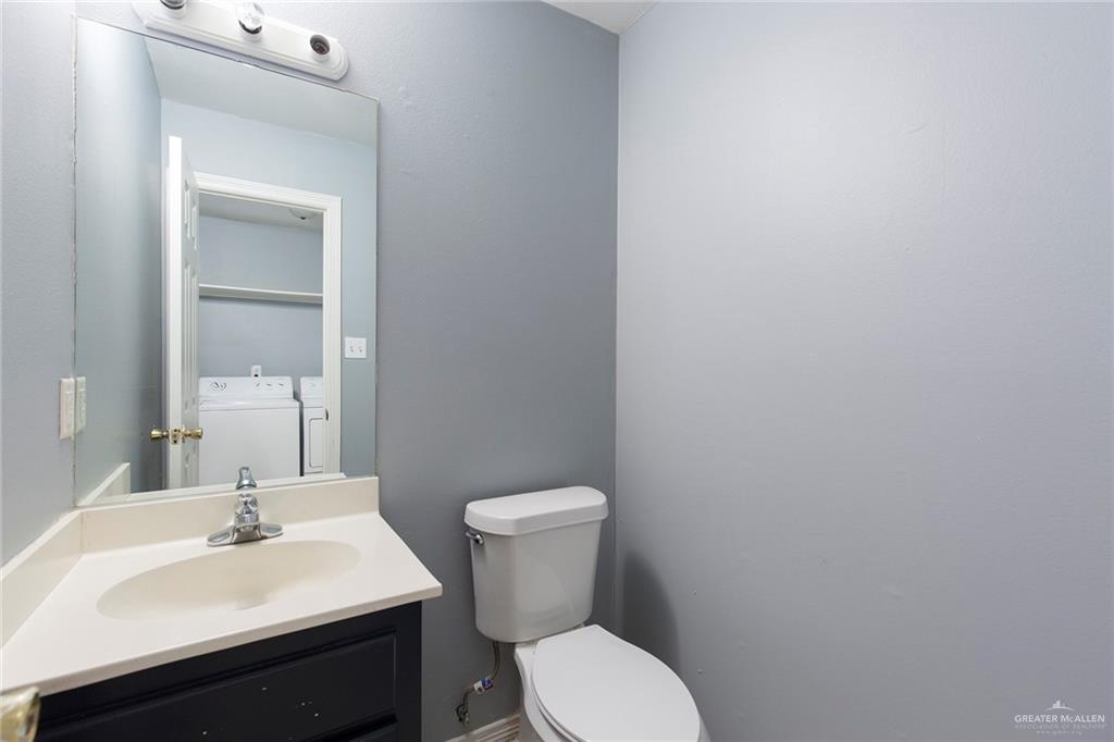 817 South Michigan Street Mission, TX 78573 - Photo 7 of 16 a bathroom with a toilet a sink and mirror
