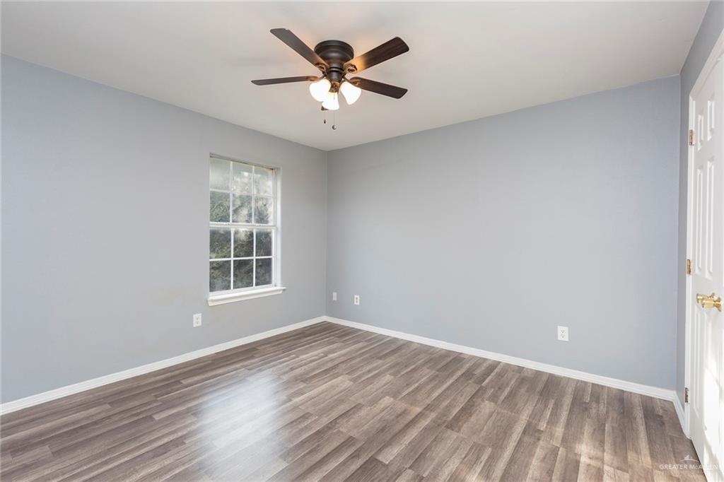 817 South Michigan Street Mission, TX 78573 - Photo 8 of 16 an empty room with wooden floor and windows