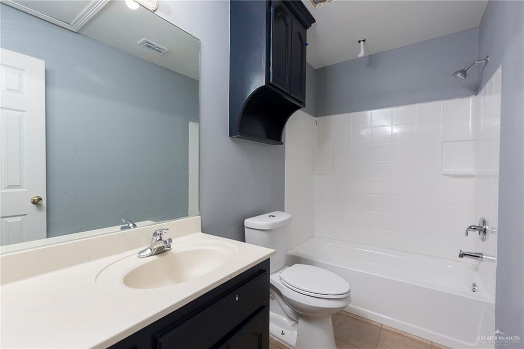 817 South Michigan Street Mission, TX 78573 - Photo 10 of 16 a bathroom with a sink a toilet and shower