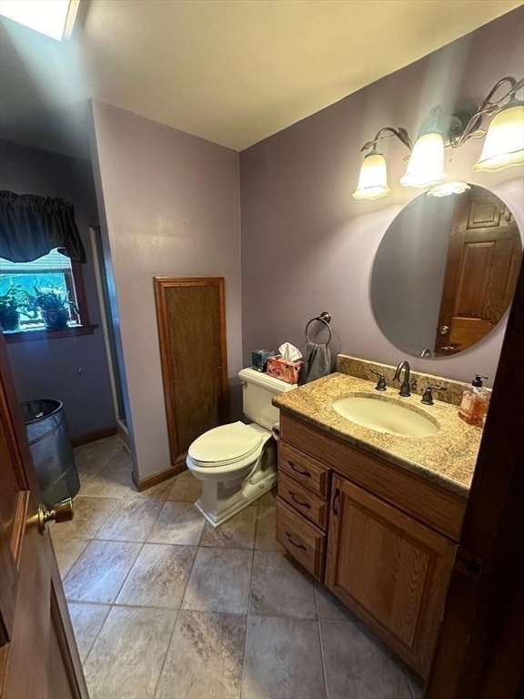 99 Old Poor Farm Road Ware, MA 01082 - Photo 15 of 29 a bathroom with a granite countertop toilet sink and mirror