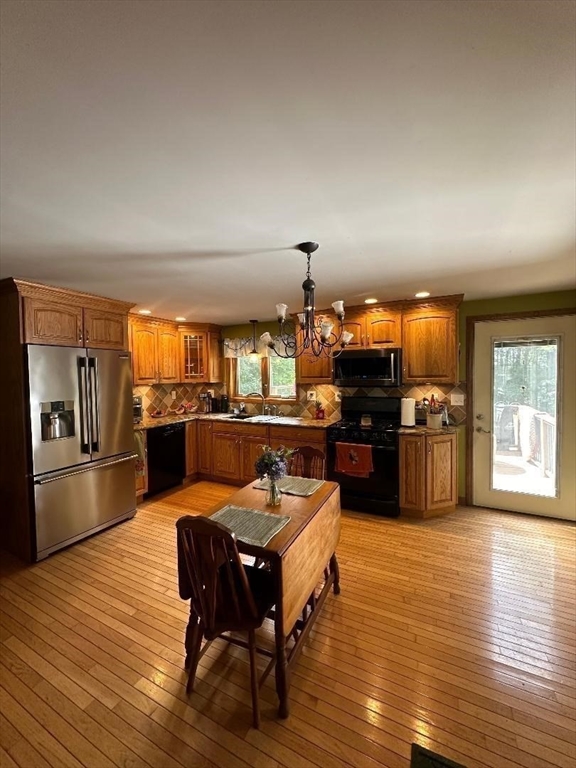 99 Old Poor Farm Road Ware, MA 01082 - Photo 9 of 29 a large open kitchen with a table and chairs