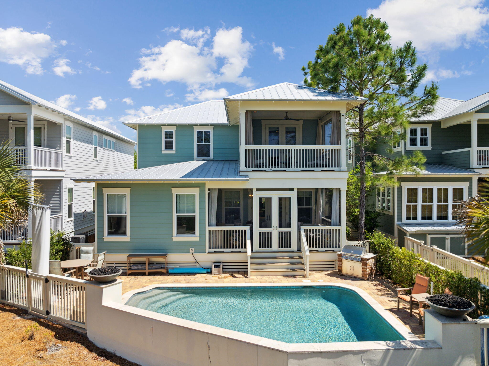 a view of a house with swimming pool and sitting area