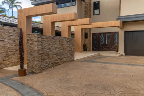 a view of a swimming pool with a yard and palm trees