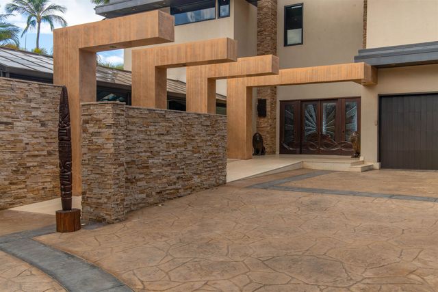 a view of a swimming pool with a yard and palm trees
