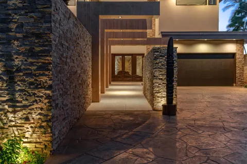a view of a chairs and table in patio with swimming pool