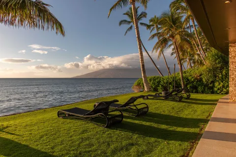 a bedroom with a bed a couch and large window
