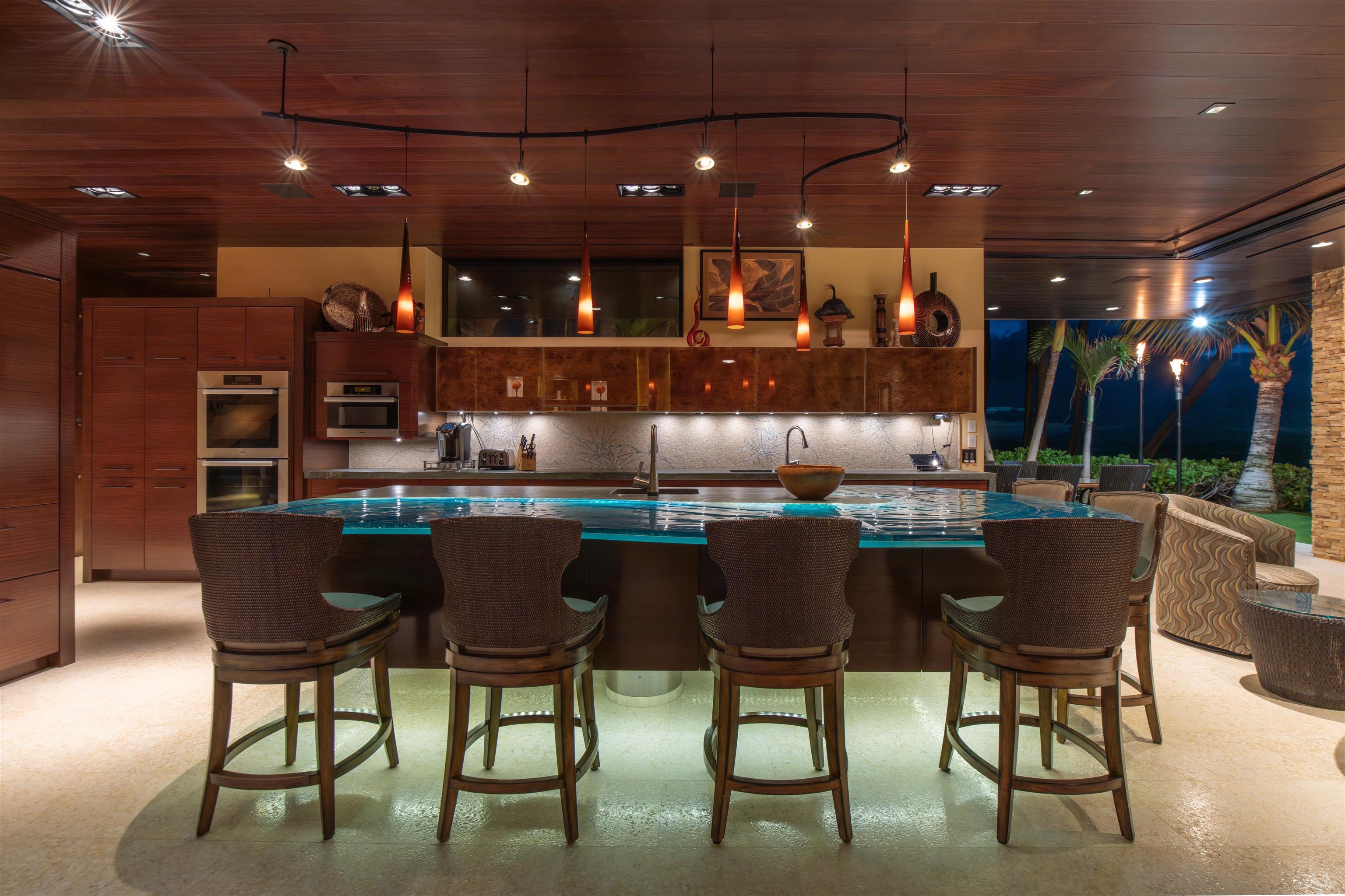 1750 Halama Street Kihei, HI 96753 - Photo 29 of 50 a dining area with furniture and a chandelier