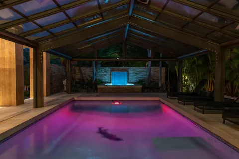 a backyard of a house with yard table and chairs