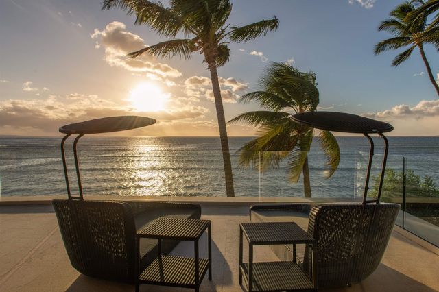 a building outdoor space with patio furniture and potted plants